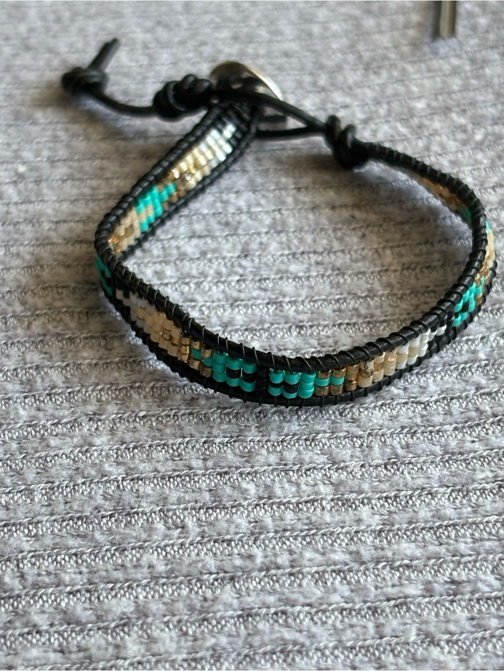 Bohemian theme blue, white, gold tone & black microbeaded adjustable bracelet